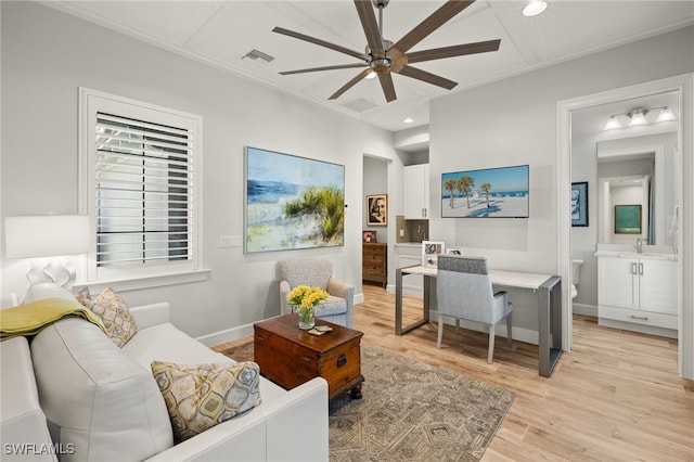 interior space with sink, ceiling fan, and light hardwood / wood-style flooring