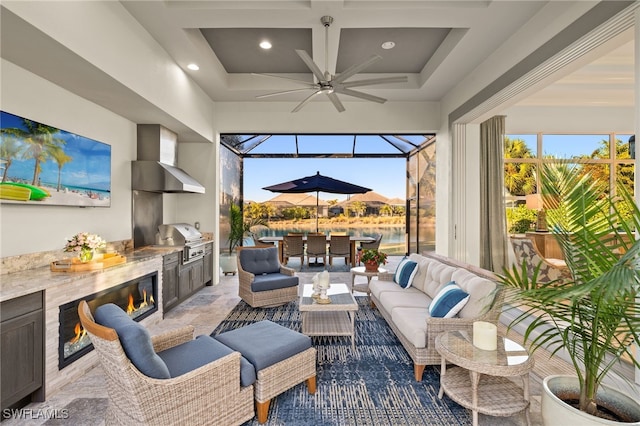 interior space featuring beamed ceiling, a water view, coffered ceiling, and ceiling fan