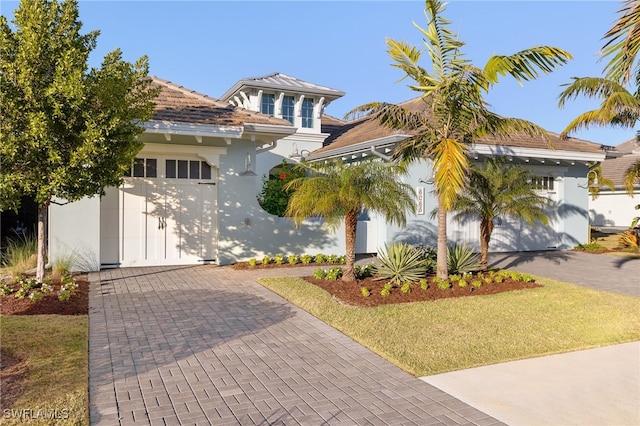 view of front of house with a garage and a front lawn