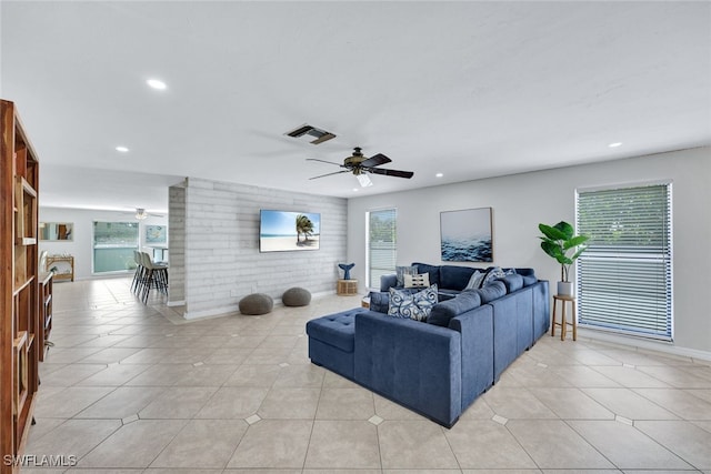 tiled living room featuring ceiling fan