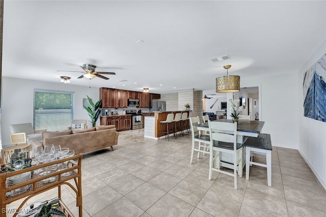 dining room with ceiling fan and light tile patterned floors