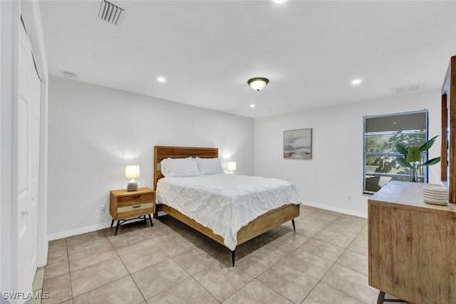 bedroom featuring a closet and light tile patterned floors