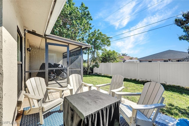 view of patio / terrace featuring a sunroom