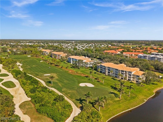 aerial view with golf course view and a water view