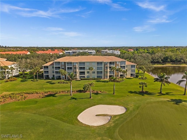 surrounding community with view of golf course, a yard, and a water view