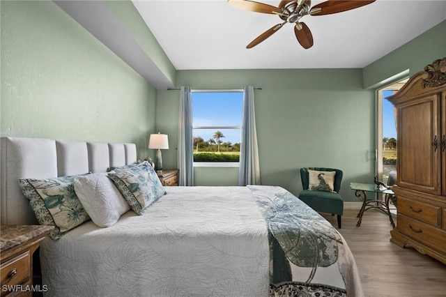 bedroom featuring ceiling fan, baseboards, and wood finished floors