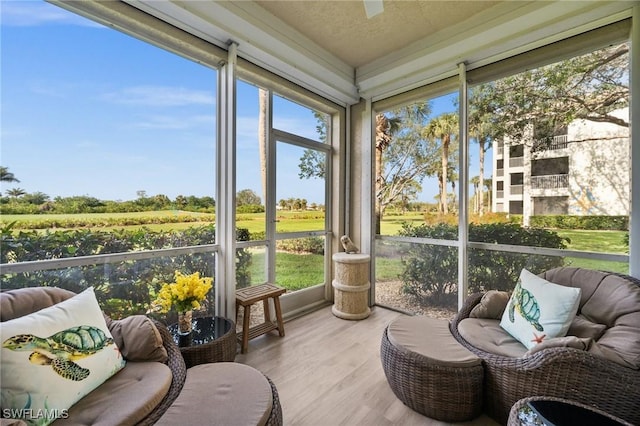 sunroom featuring a ceiling fan