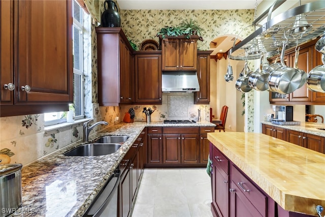 kitchen with wooden counters, stainless steel dishwasher, and sink