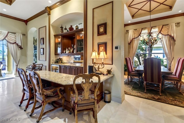 dining space with crown molding and a chandelier