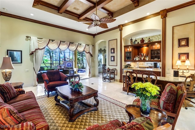 living room with ceiling fan, beamed ceiling, coffered ceiling, and ornamental molding