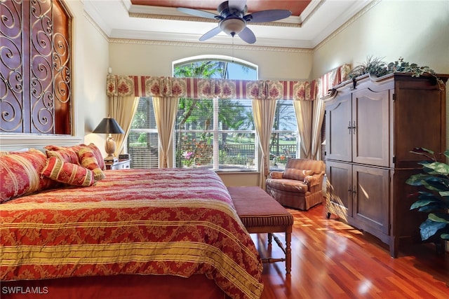 bedroom with hardwood / wood-style floors, ceiling fan, and ornamental molding