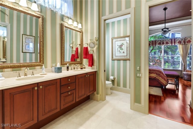 bathroom with ceiling fan, toilet, and vanity