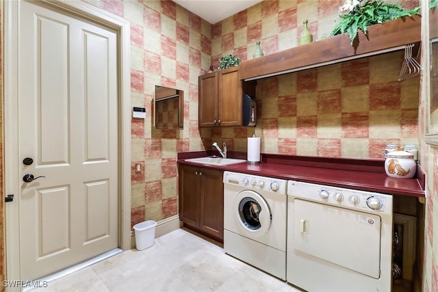 washroom featuring cabinets, washer and dryer, and sink