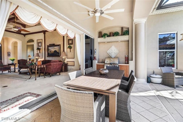 view of patio featuring ceiling fan, area for grilling, and grilling area