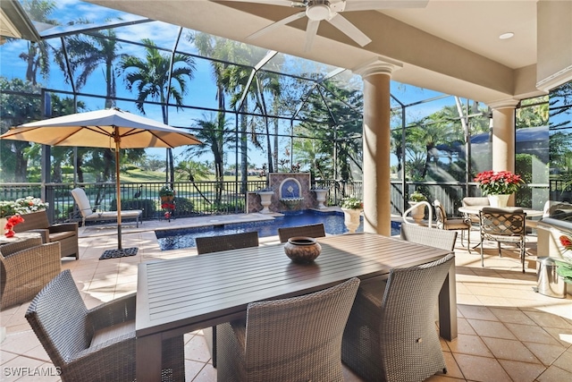 view of patio with a lanai, ceiling fan, and an outdoor fireplace