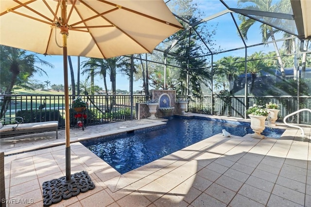 view of swimming pool featuring pool water feature, glass enclosure, and a patio area