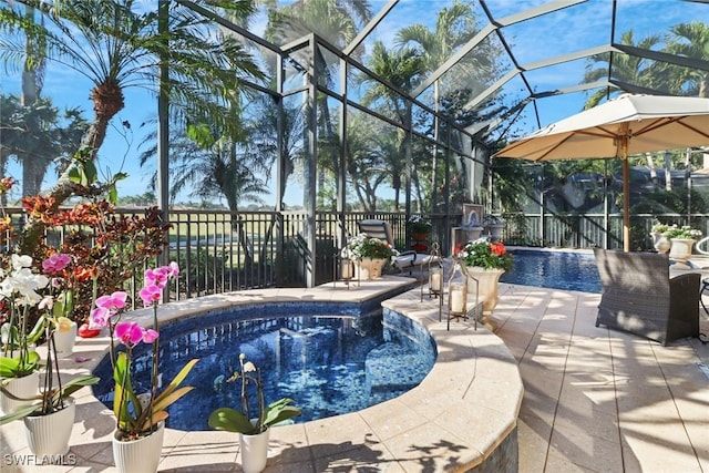 view of swimming pool featuring a lanai and a patio