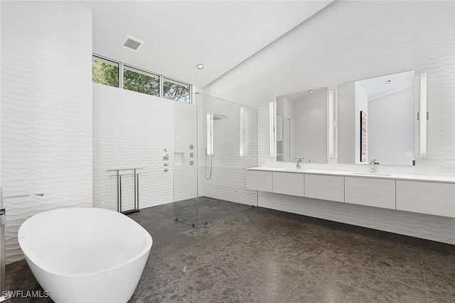 bathroom featuring a sink, a shower stall, visible vents, a freestanding bath, and double vanity