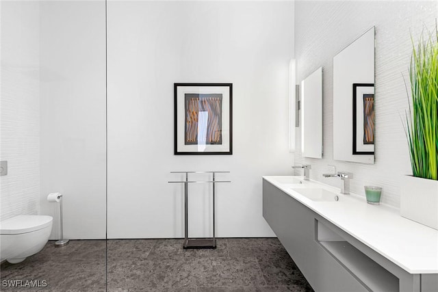 full bathroom featuring toilet, vanity, and tasteful backsplash