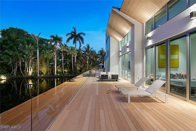 wooden deck featuring a water view