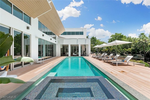 view of pool featuring a pool with connected hot tub and a wooden deck