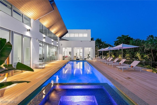 pool with an in ground hot tub and a deck
