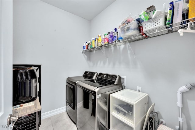 laundry room featuring washer and dryer and light tile patterned floors