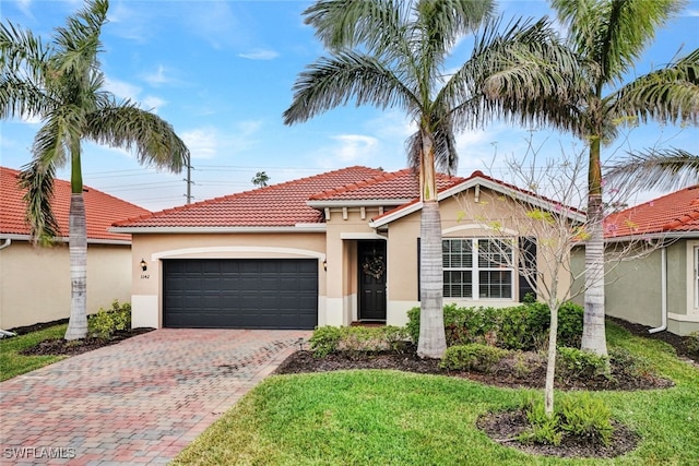 mediterranean / spanish house featuring a front lawn and a garage