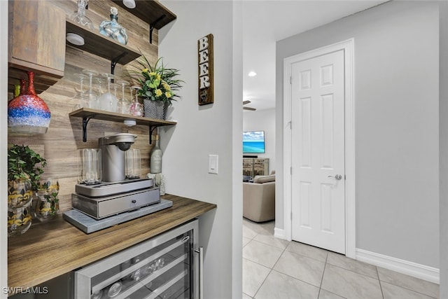 kitchen with beverage cooler, ceiling fan, and light tile patterned floors