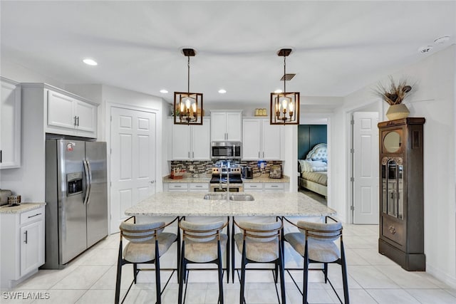 kitchen featuring light stone counters, white cabinets, and appliances with stainless steel finishes