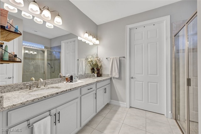 bathroom featuring vanity, an enclosed shower, and tile patterned flooring