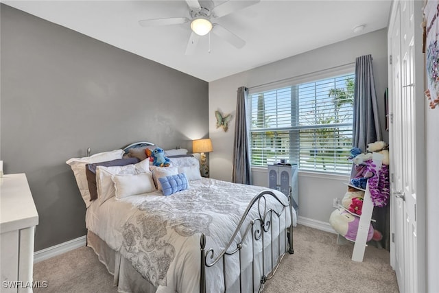 bedroom featuring light colored carpet and ceiling fan