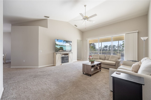 living room with ceiling fan, lofted ceiling, and light carpet