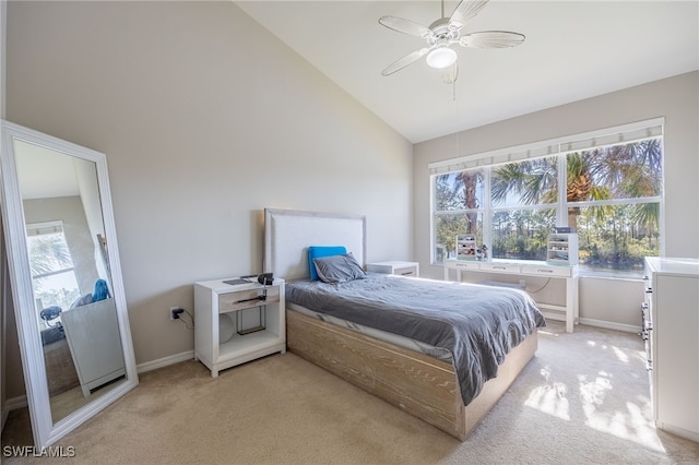 bedroom with ceiling fan, high vaulted ceiling, and light colored carpet