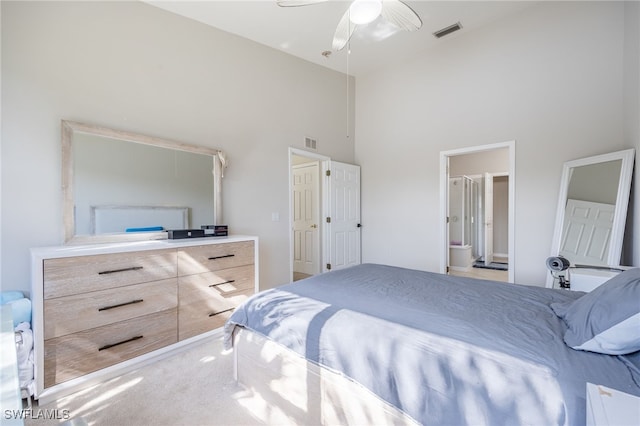 bedroom featuring carpet, high vaulted ceiling, ensuite bath, and ceiling fan