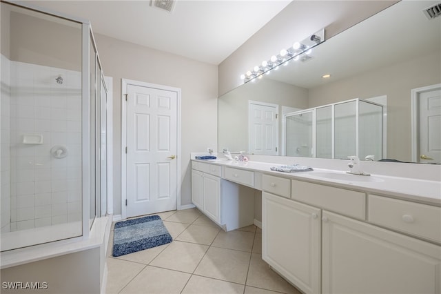 bathroom featuring tile patterned flooring, vanity, and an enclosed shower