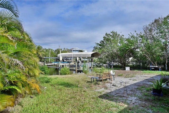 exterior space featuring a dock and a water view