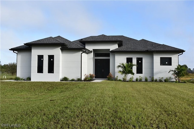 prairie-style home featuring a front lawn