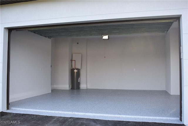 garage featuring electric water heater and a garage door opener