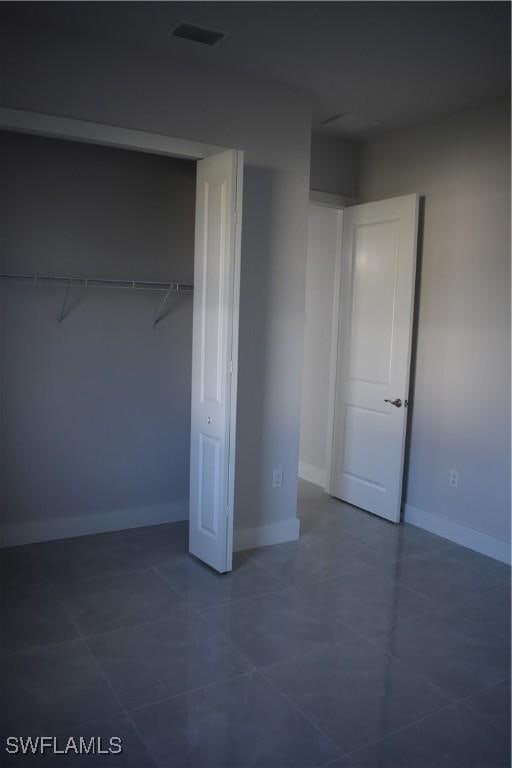 unfurnished bedroom featuring tile patterned floors and a closet