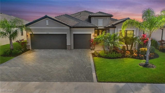 view of front of property featuring a lawn and a garage