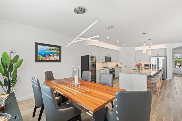 dining area with light hardwood / wood-style flooring