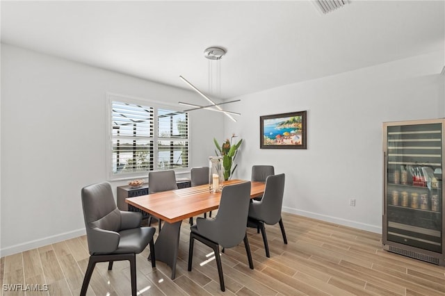 dining area featuring light hardwood / wood-style floors and beverage cooler