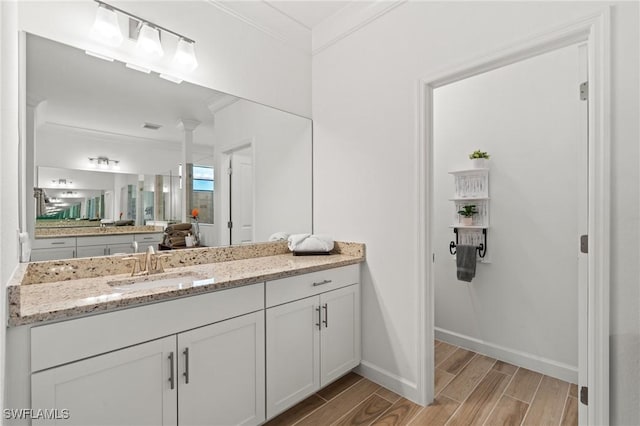 bathroom featuring vanity and ornamental molding