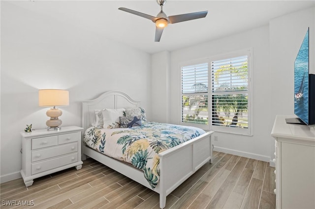 bedroom with ceiling fan and light wood-type flooring