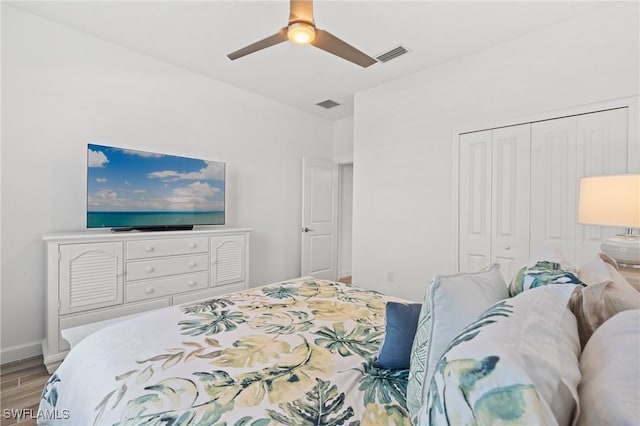 bedroom with ceiling fan, light hardwood / wood-style floors, and a closet