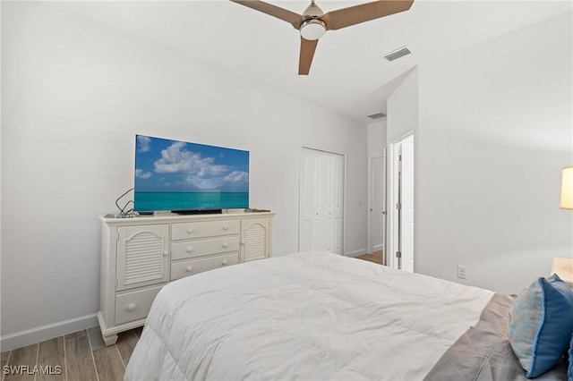 bedroom with ceiling fan and a closet