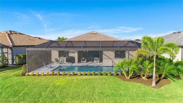 back of house with a lanai and a lawn