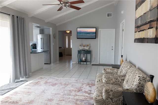 living room with light tile patterned floors, vaulted ceiling with beams, and ceiling fan