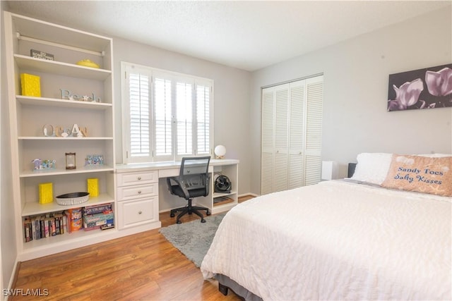 bedroom with a closet and light hardwood / wood-style flooring